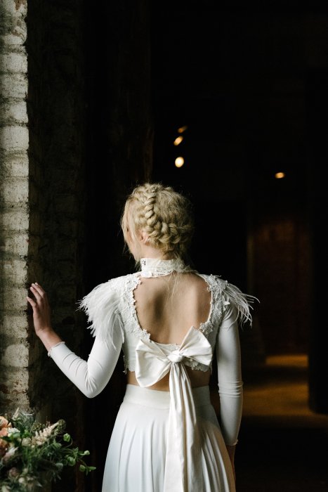 blond hair bride with open back white dress with a bow in Thessaloniki 