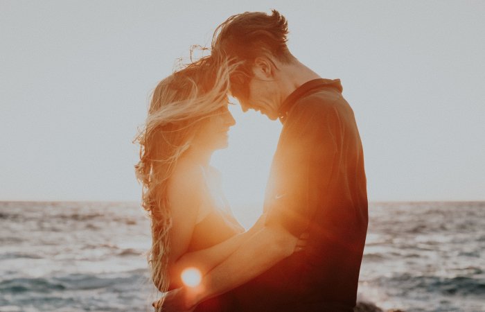 Couple on the beach with sunset at destination wedding