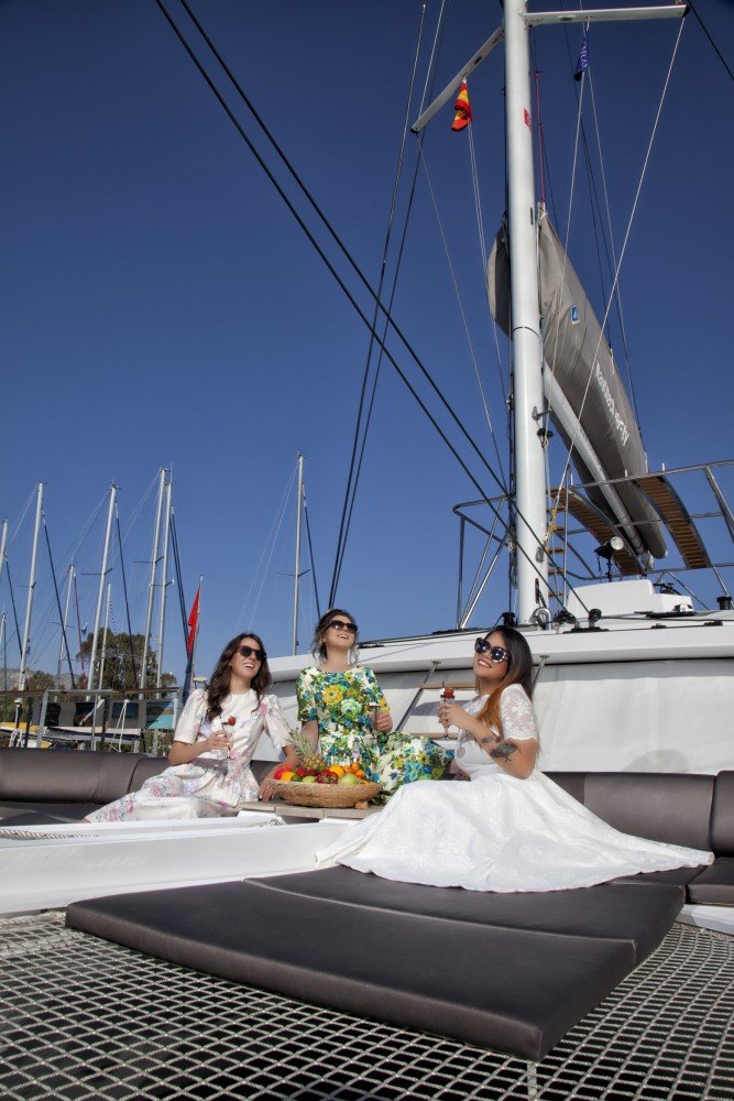 Summer jet-set cruise bride with bridesmaids having fun of the yacht in Greece