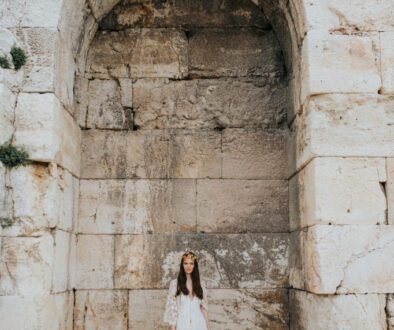 Bride under the arch near the acropolis in Athens