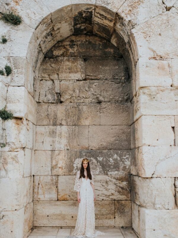 Bride under the arch near the acropolis in Athens