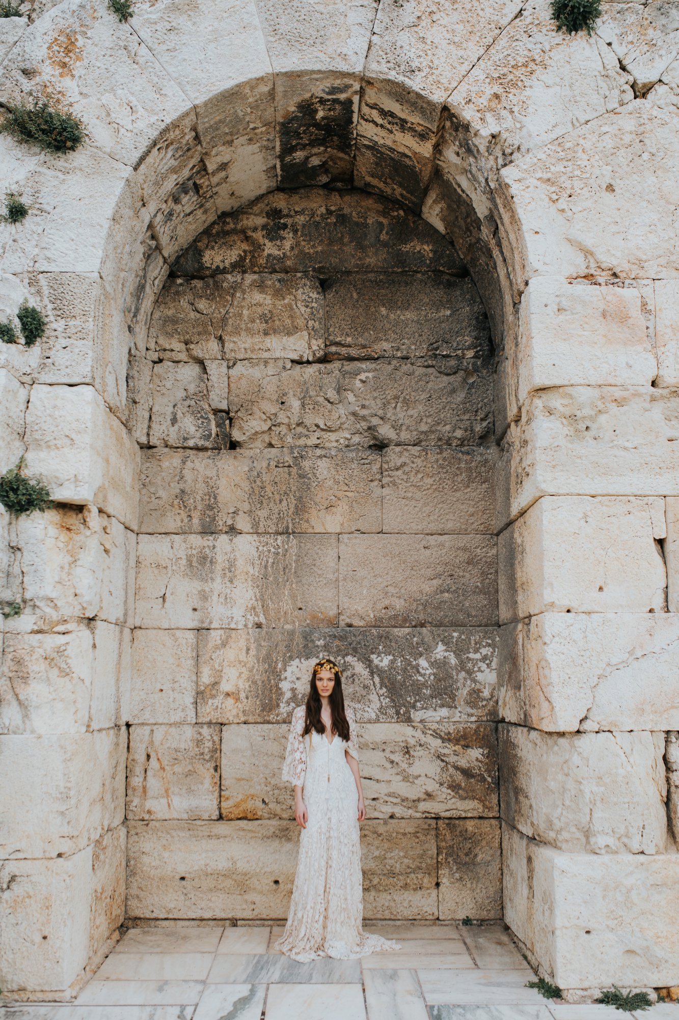 Bride under the arch near the acropolis in Athens