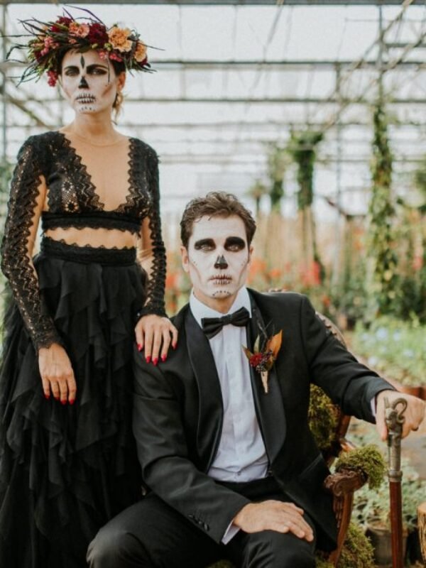 Halloween Wedding couple groom and bride sitting in Greenhouse
