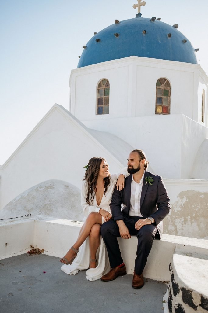 stylish Santorini elopement couple sitting