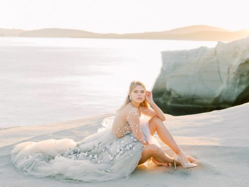 Bride sitting on the rocks in Milos Sarakiniko beach