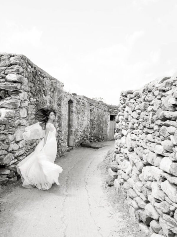 Bride running amongst the ruins on Naxos Island in Greece