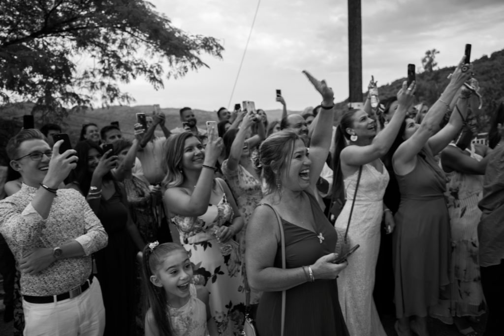 People filming at the happy couple with their cellphones