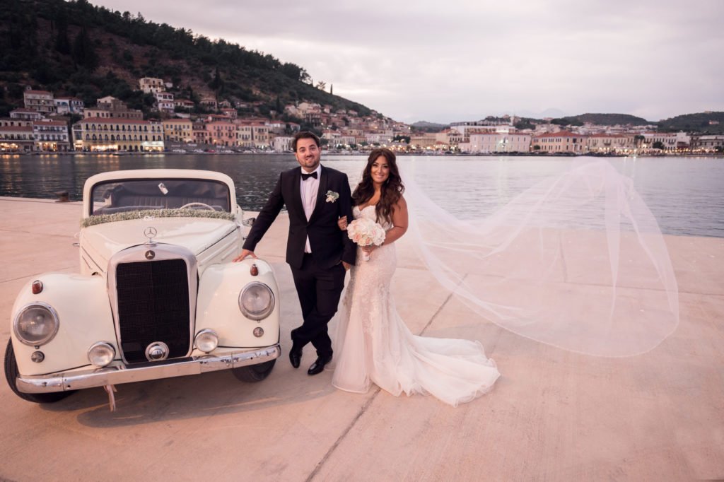 Couple standing near a vintage car in Gytheio