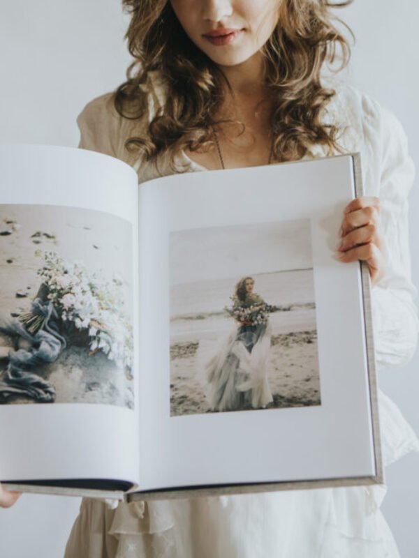 woman holding a wedding qt album heirloom edition