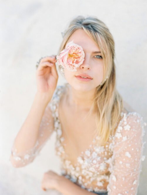 bride holding a rose on her eye