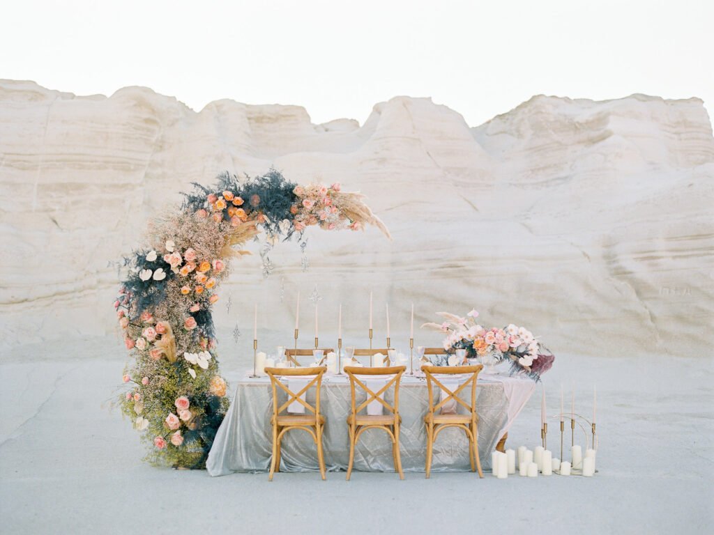 lush table setup with big lunar floral arrangement in Milos