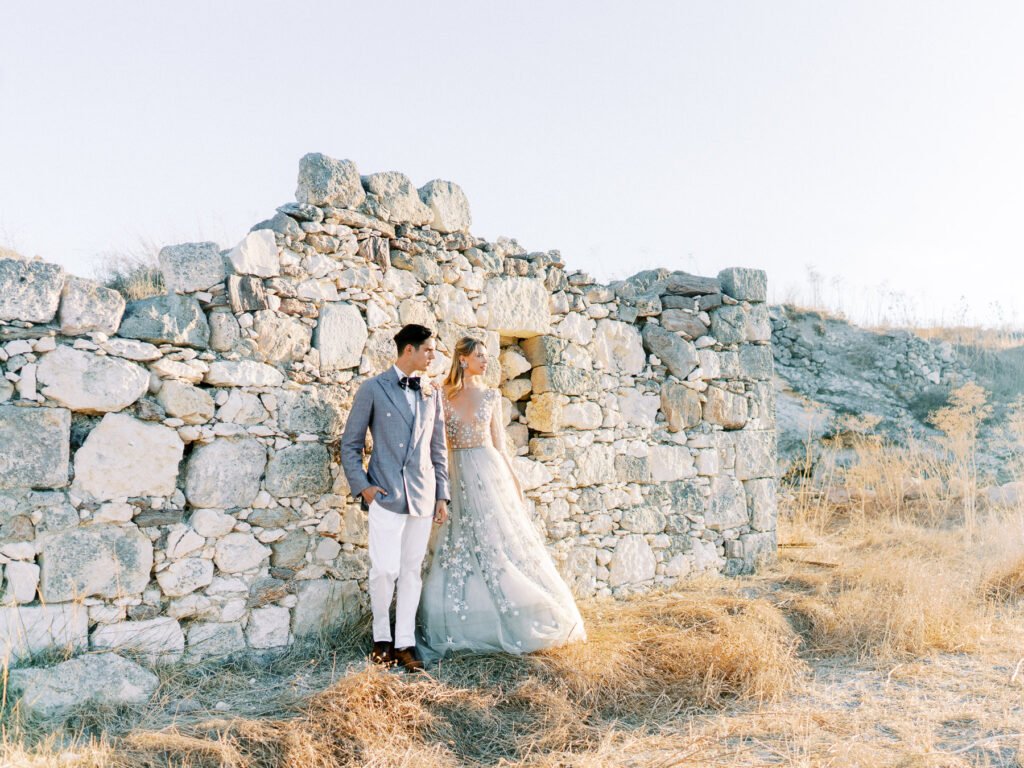 Couple at the old stone house in Milos