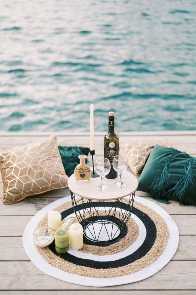 table setup with wine for The most magical engagement on a private pier that ended with a sailing yacht ride into the sunset!
