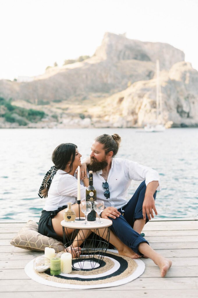 The most magical engagement on a private pier couple sitting