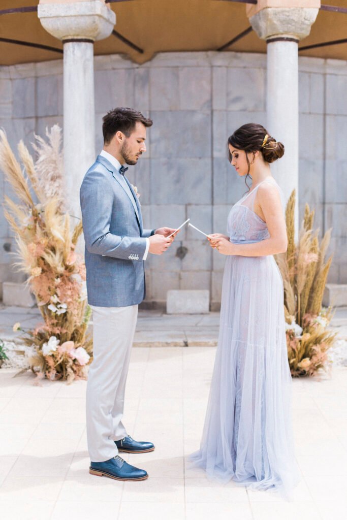 Luxury Elopement couple exchanging vows in Kavala hotel with pampas grass