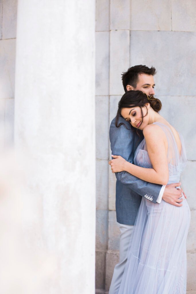 Couple hugging in dusty blue dress
