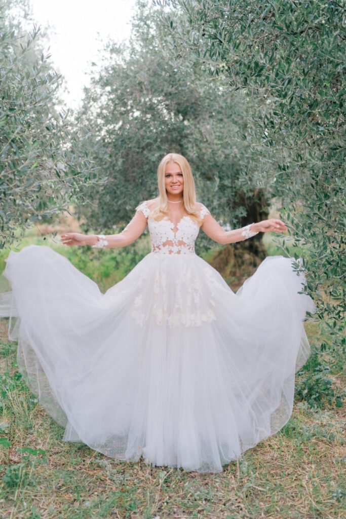 Bride and her dress in the olive grove in Crete