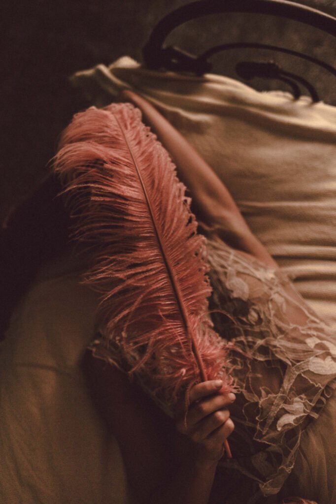Girl with feather on the bed