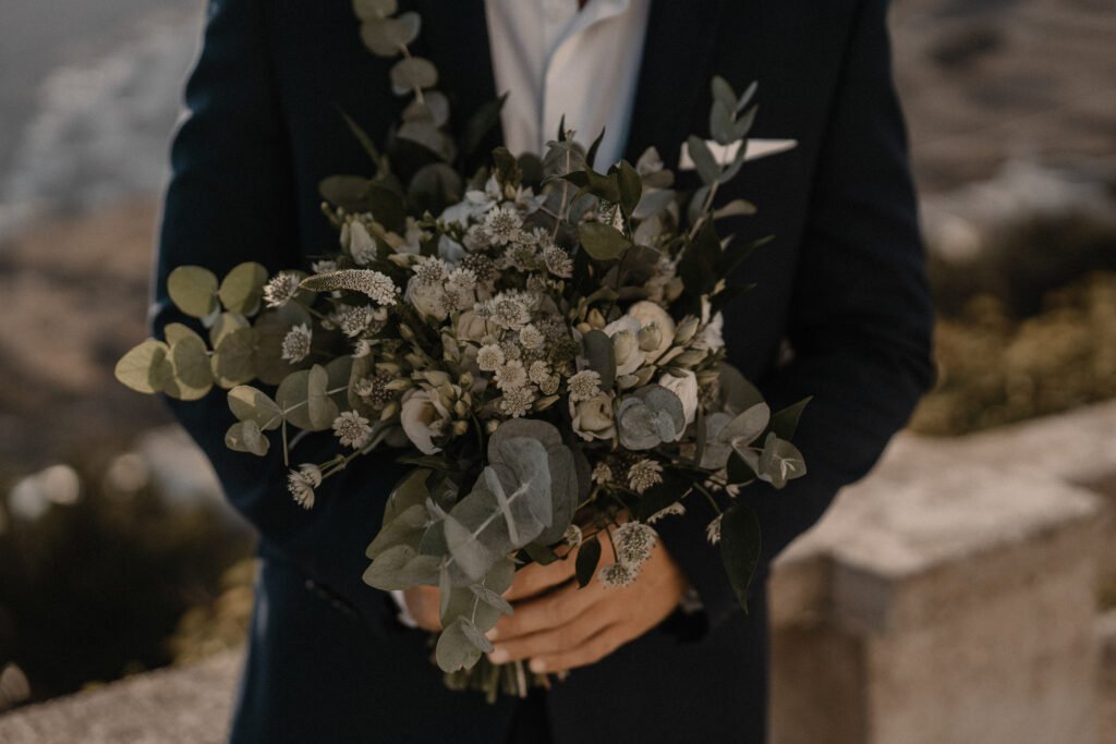 Groom Holding a bouquet of eco flowers