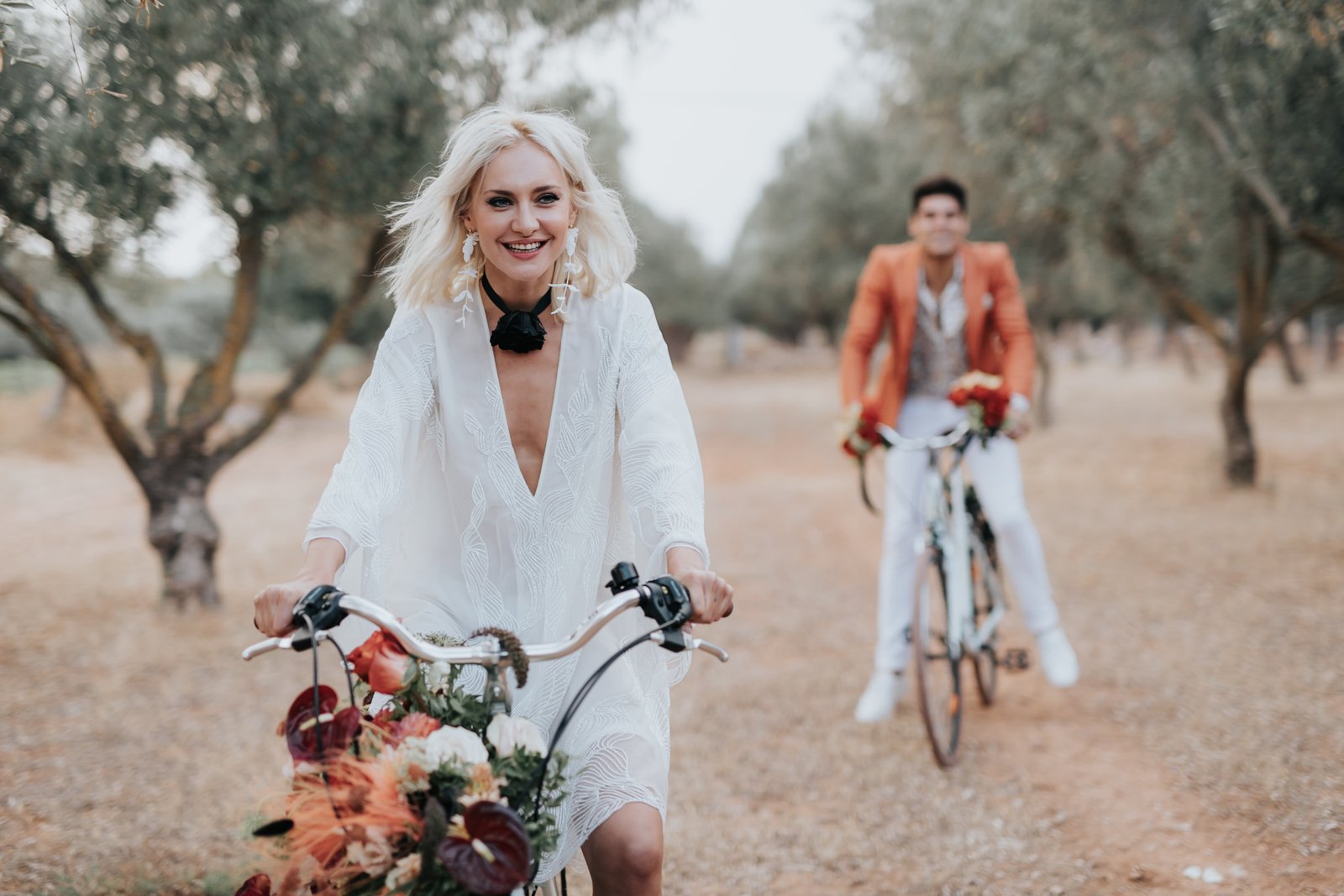 Bride and Groom driving decorated bicycles at Bohemian Rhapsody Bridal Inspiration for Alchimeia on Ellwed