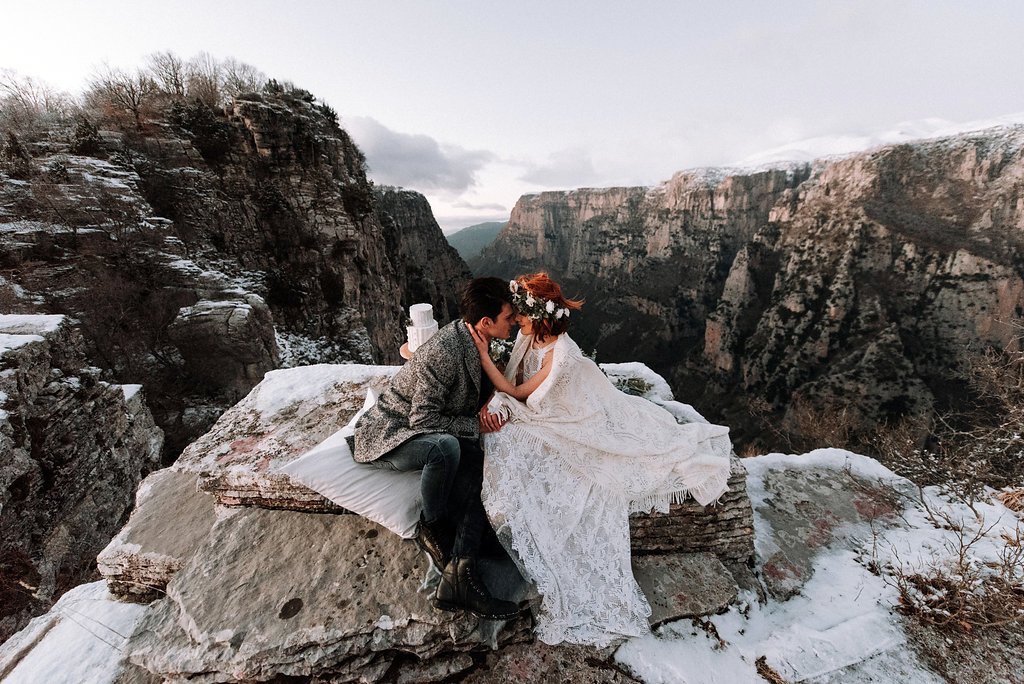 Mountain Top Elopement Inspiration from the Greek Alps with couple sitting on the edge