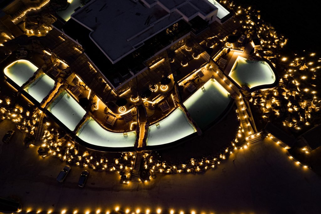 Image of the hotel from the intimate myconian wedding from above by night with light