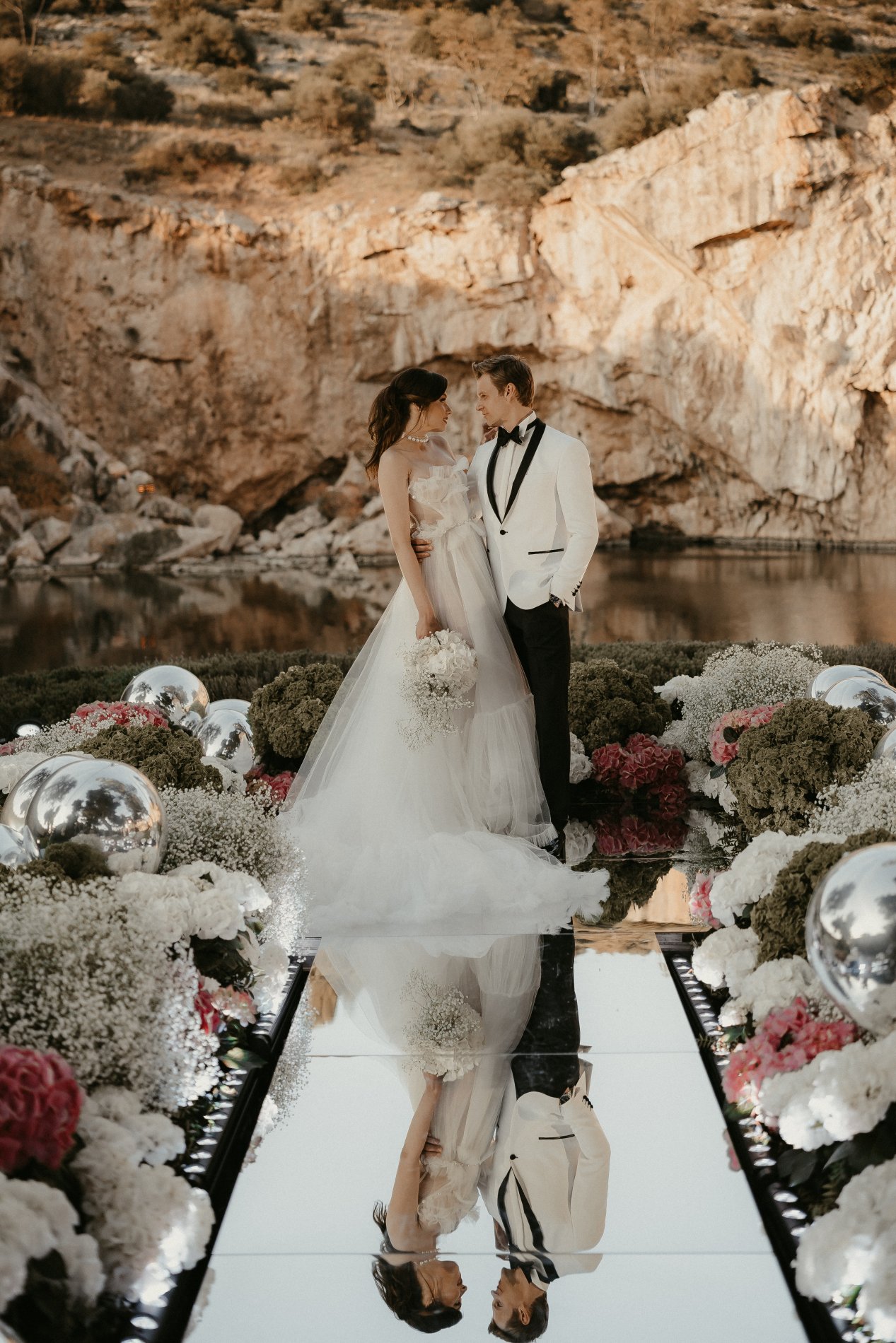 Bride and Groom standing on the mirror catwalk 