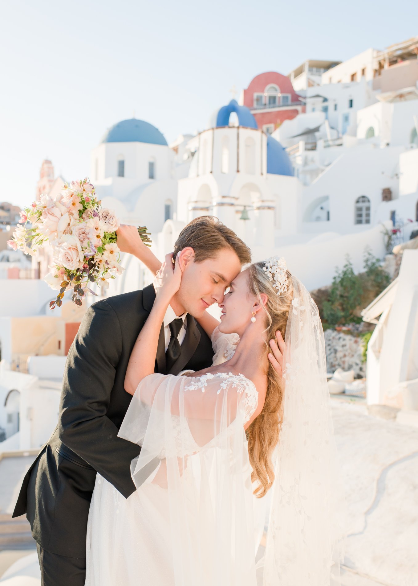 Bride and groom kissing in Santorini
