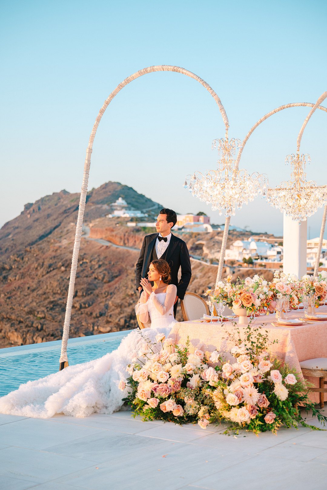 Bride and groom looking at the sunset in Santorini