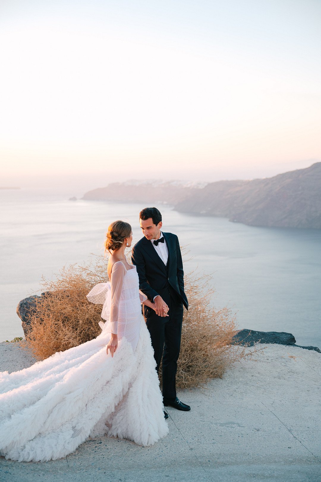 Bride and groom at sunset Sun Kissed Destination Wedding in Santorini at Rocabella