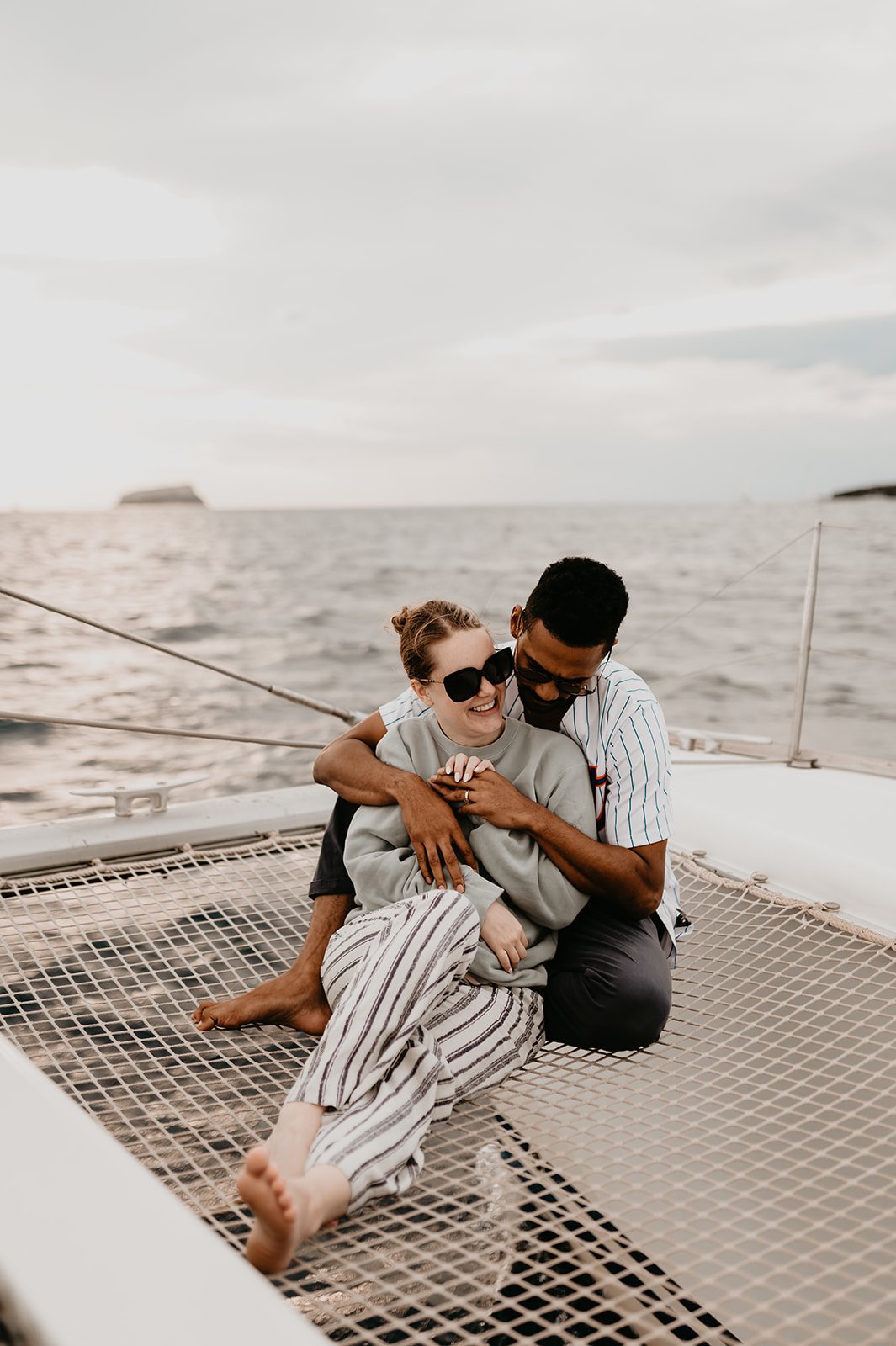 Couple hugging on the sailing boat 