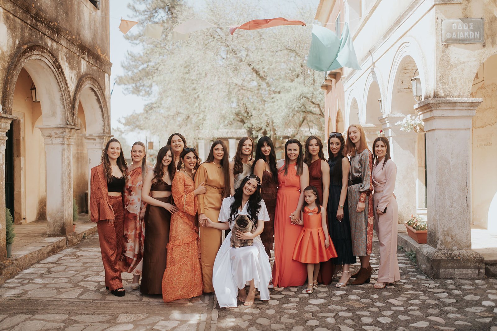 Group portrait of bridesmaids in brown and rust red for Wedding in Danilia Village Corfu