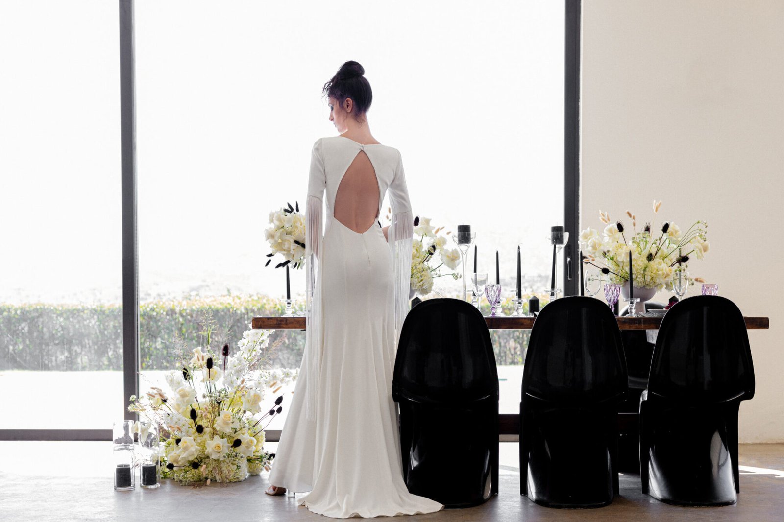 Contemporary Greek Wedding Inspiration Bride standing at the table
