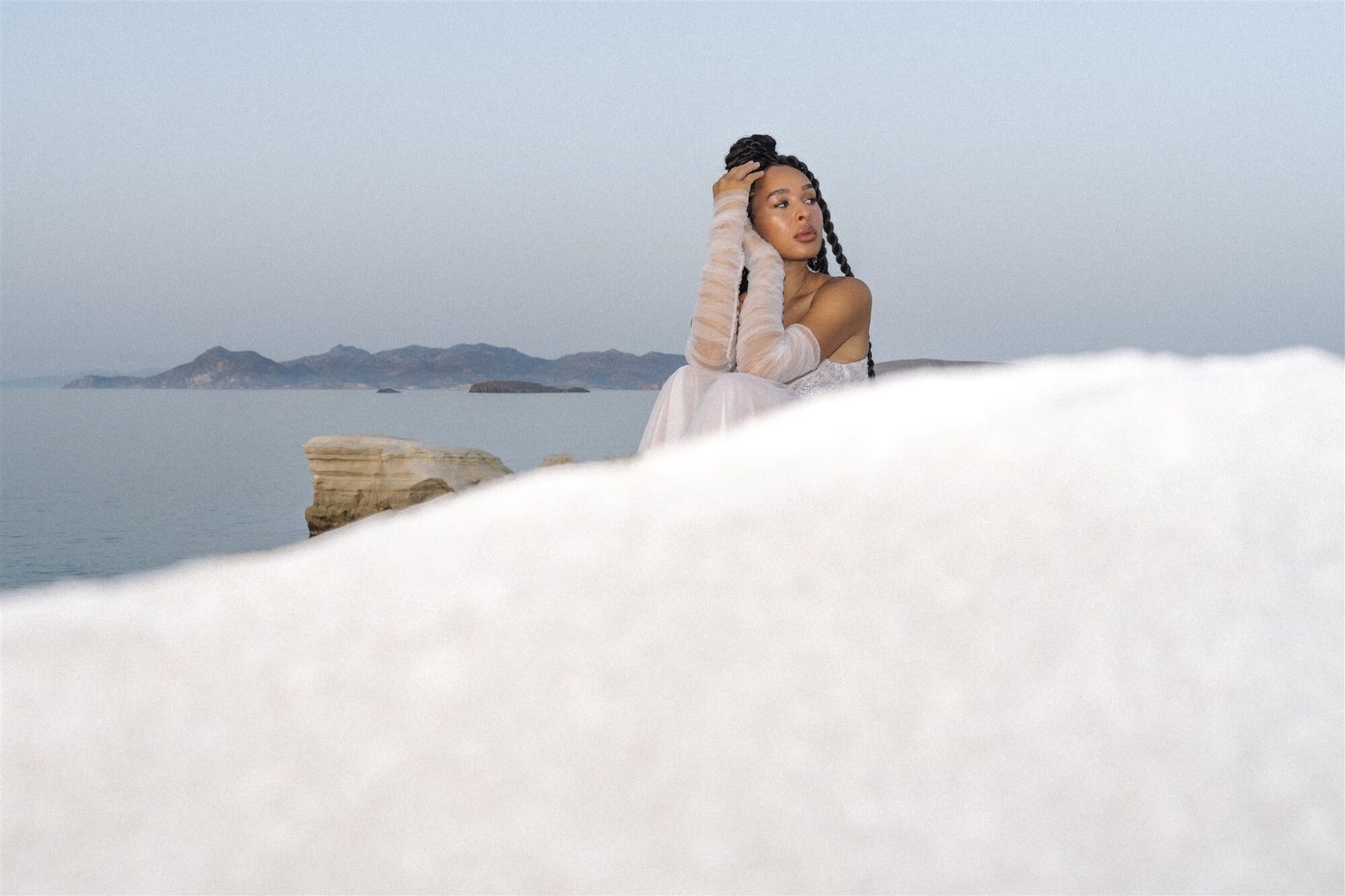 Woman sitting quietly on the beach in Greece 