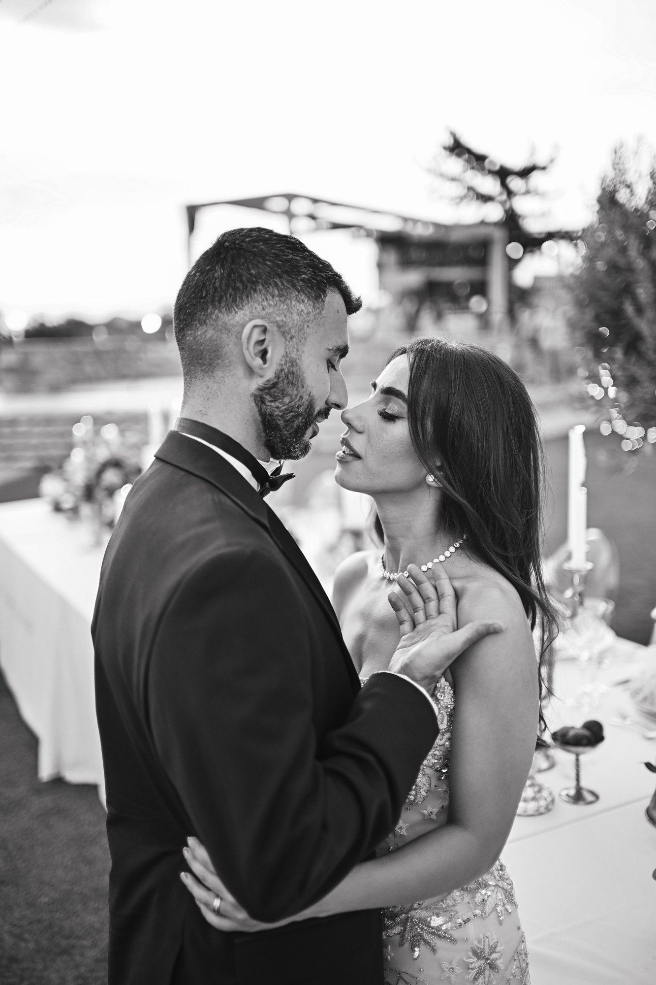 Groom kissing a bride bide in black and white phot 