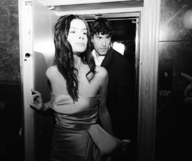 Black and white photo with flash of a couple in love exiting the elevator in their wedding resort hotel venue in Athens Greece