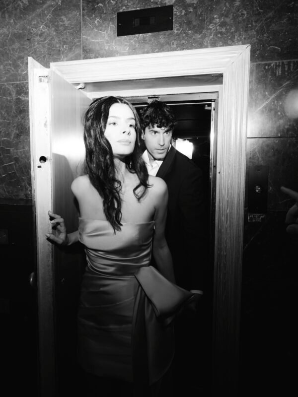Black and white photo with flash of a couple in love exiting the elevator in their wedding resort hotel venue in Athens Greece