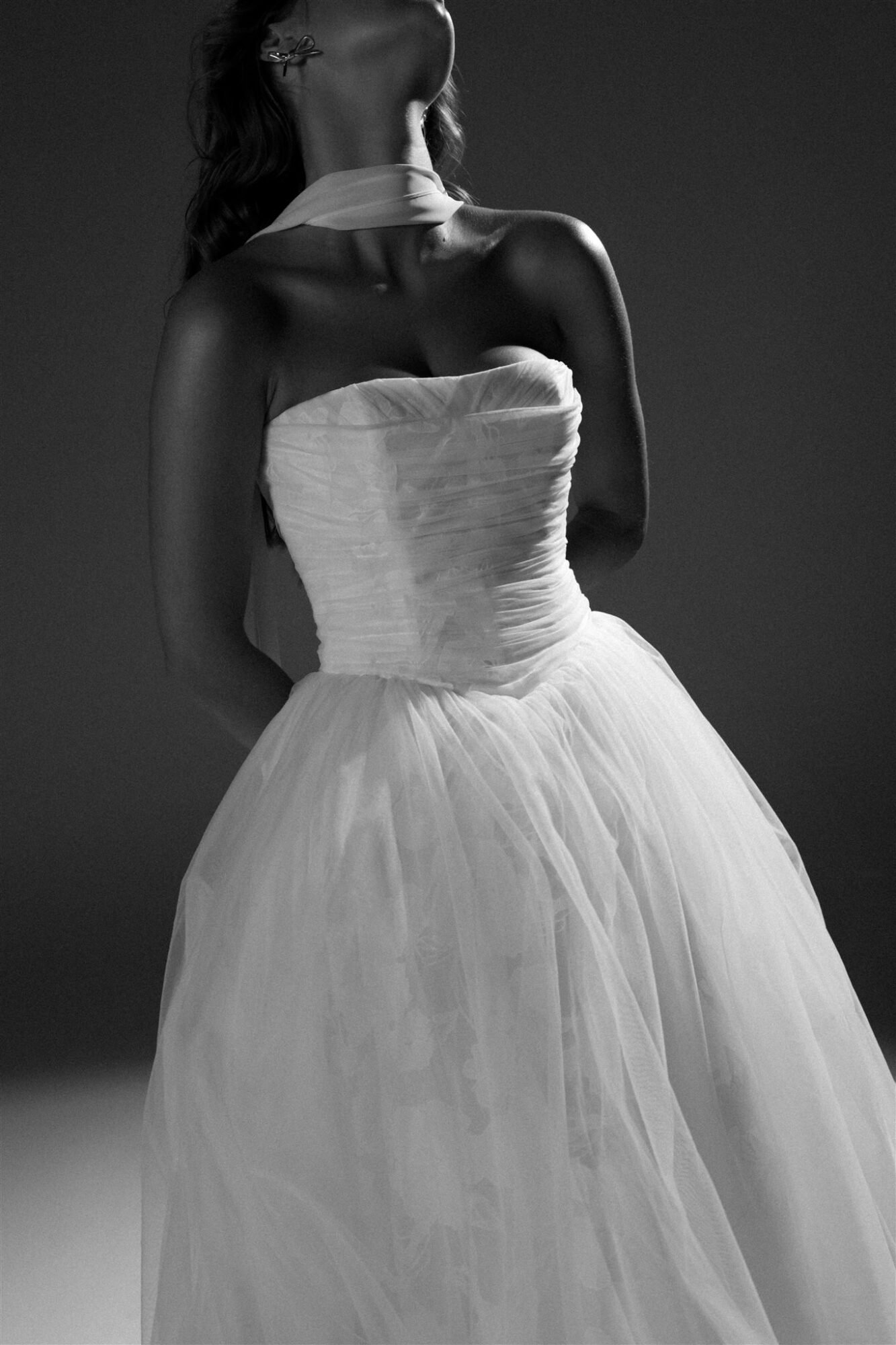 Hera Couture Serene Echoes flowing organza wedding gown on Santorini cliff with Aegean backdrop