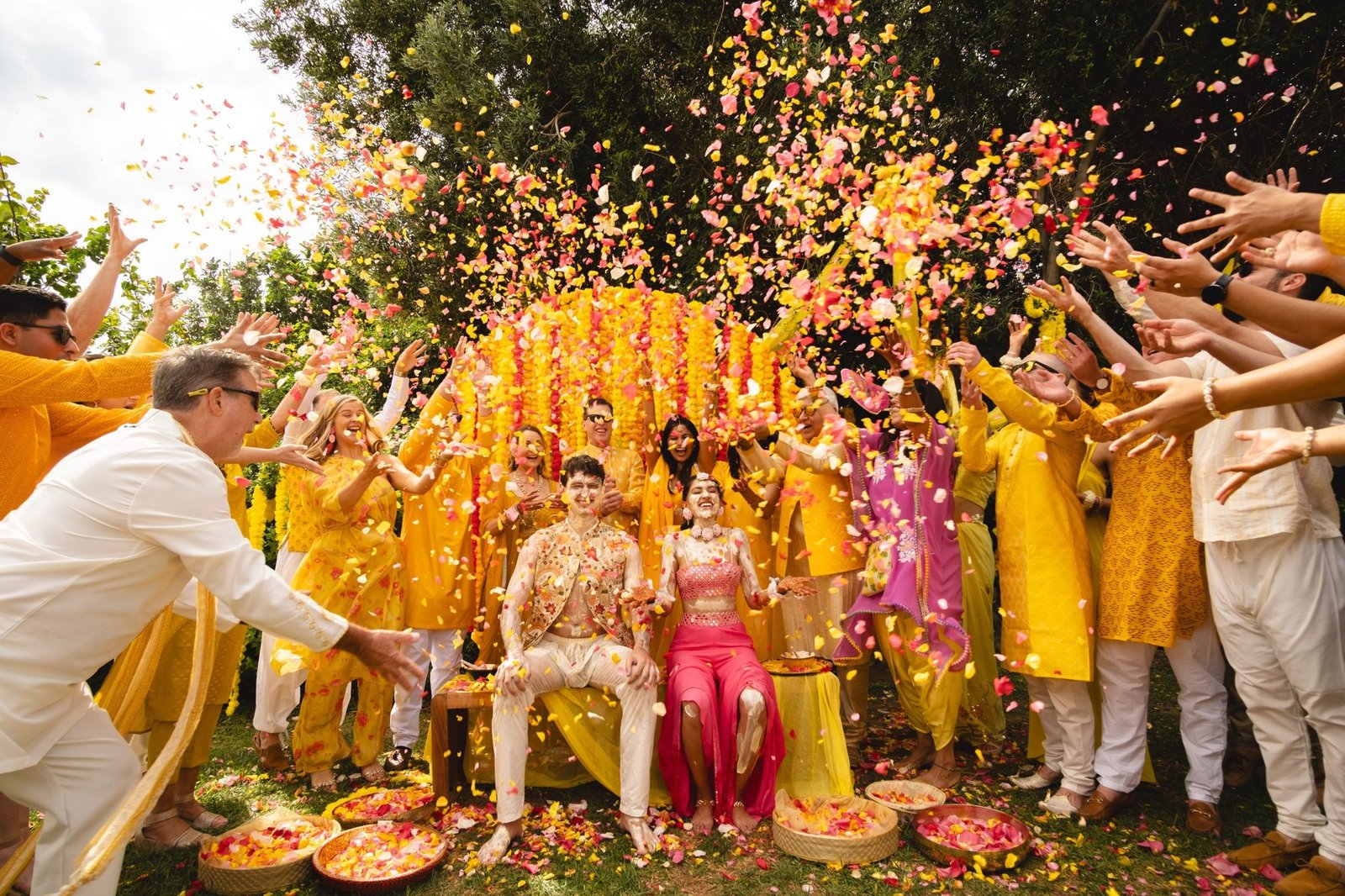 Group picture at the traditional Haldi ceremony during a grand Indian wedding at Grand Resort Lagonissi beach in Greece 
