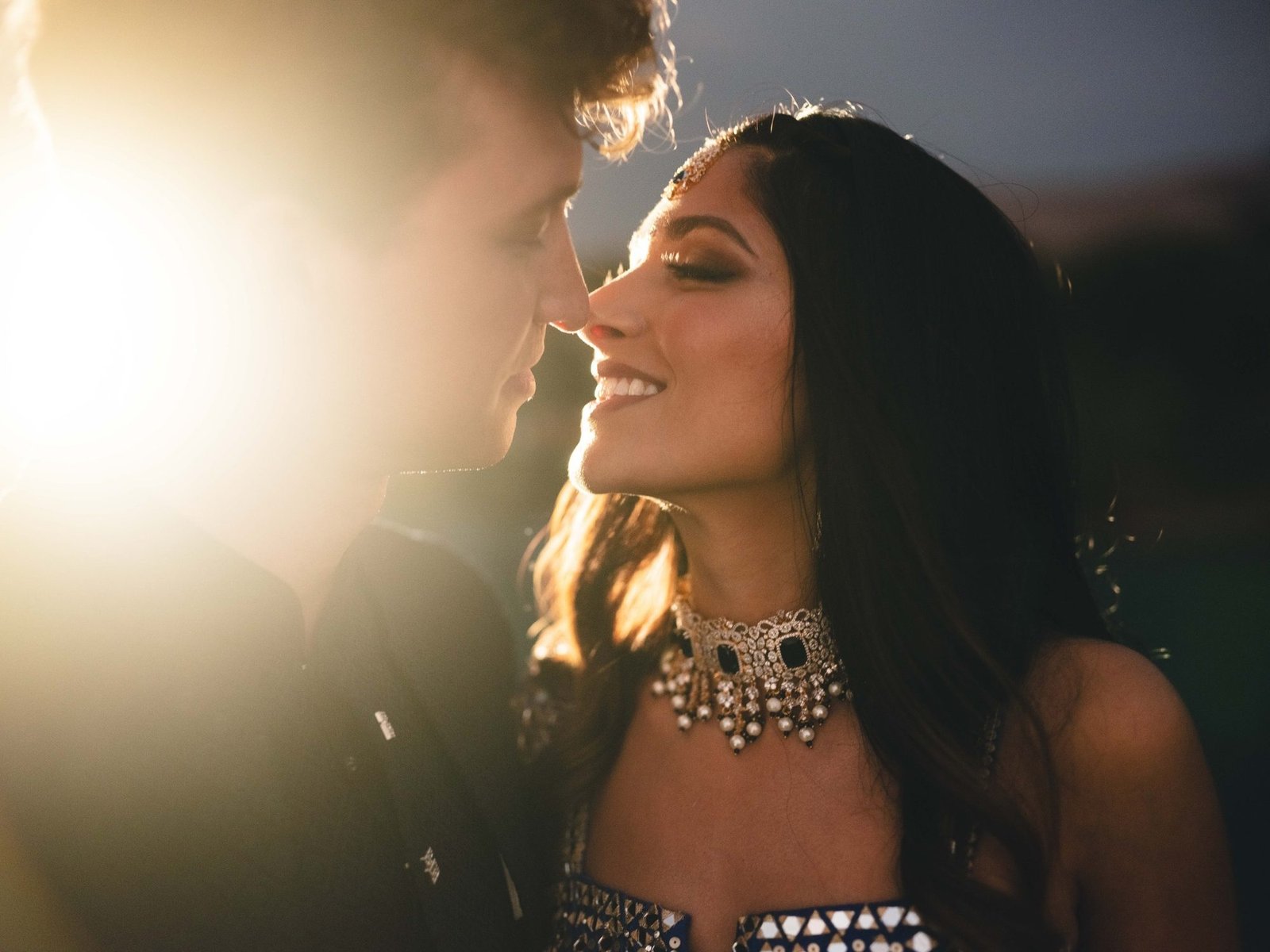 Bride and Groom portrait with sunlight  at an outdoor Sangeet venue in Athens