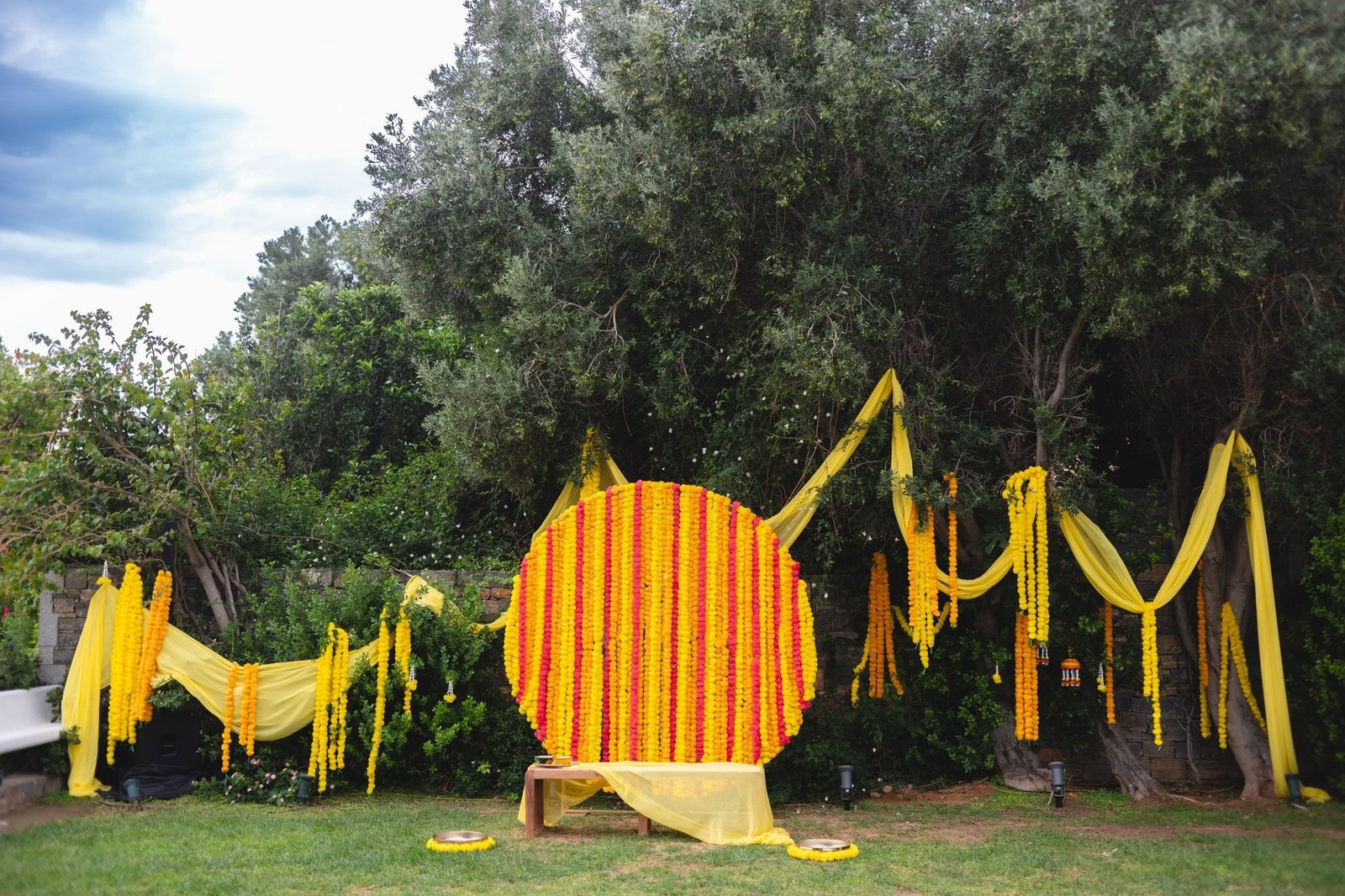 yellow and pink decor setup for beachfront Haldi and Mehndi celebration at the Grand Resort Lagonissi 