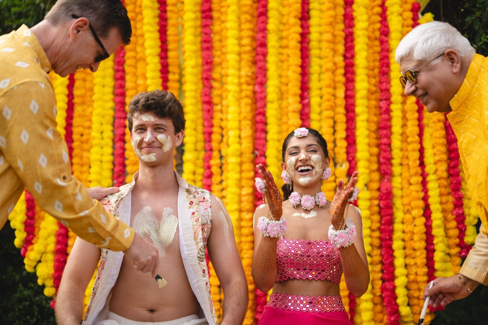 Bride in pink dress smiling during her beachfront Haldi and Mehndi celebration in the Athenian Riviera