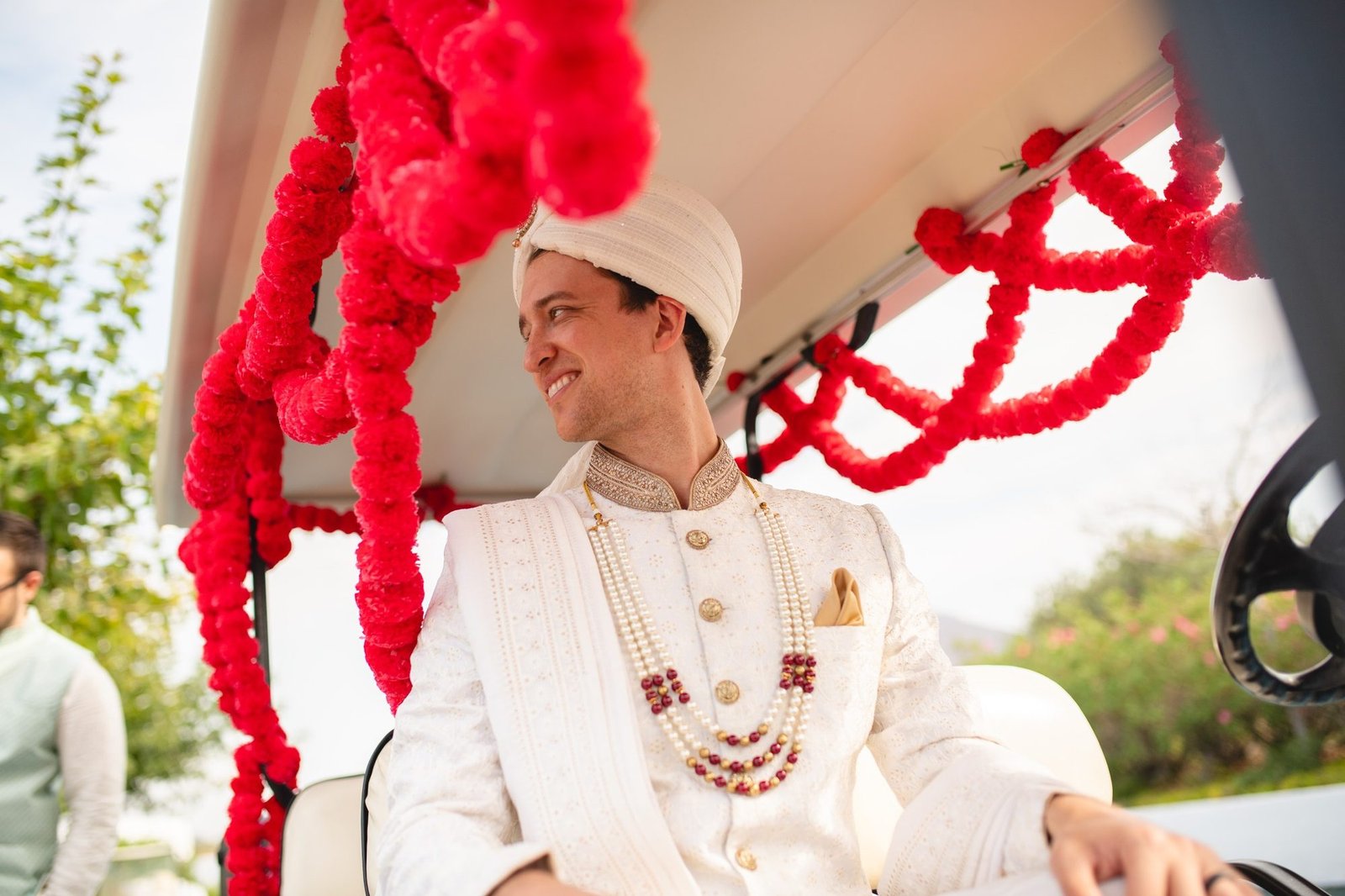 Groom celebrating his Baraat on a decorated golf cart at the Grand Resort Lagonissi helipad