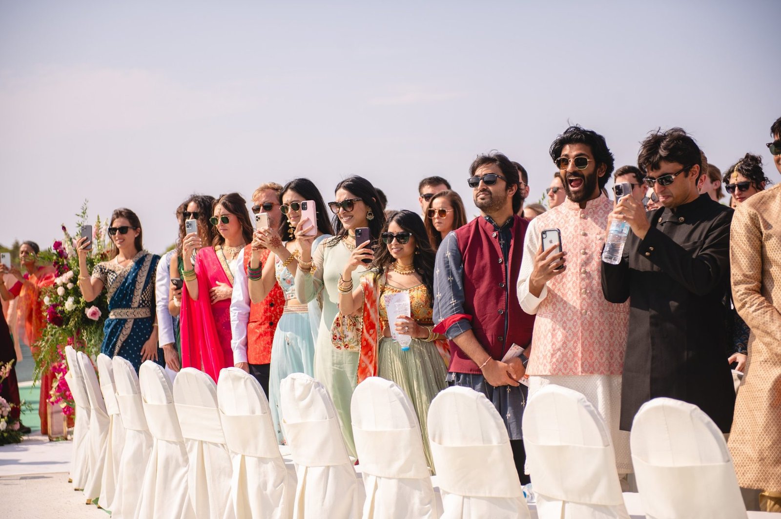 Group picture of guests looking at the bridal arrival 