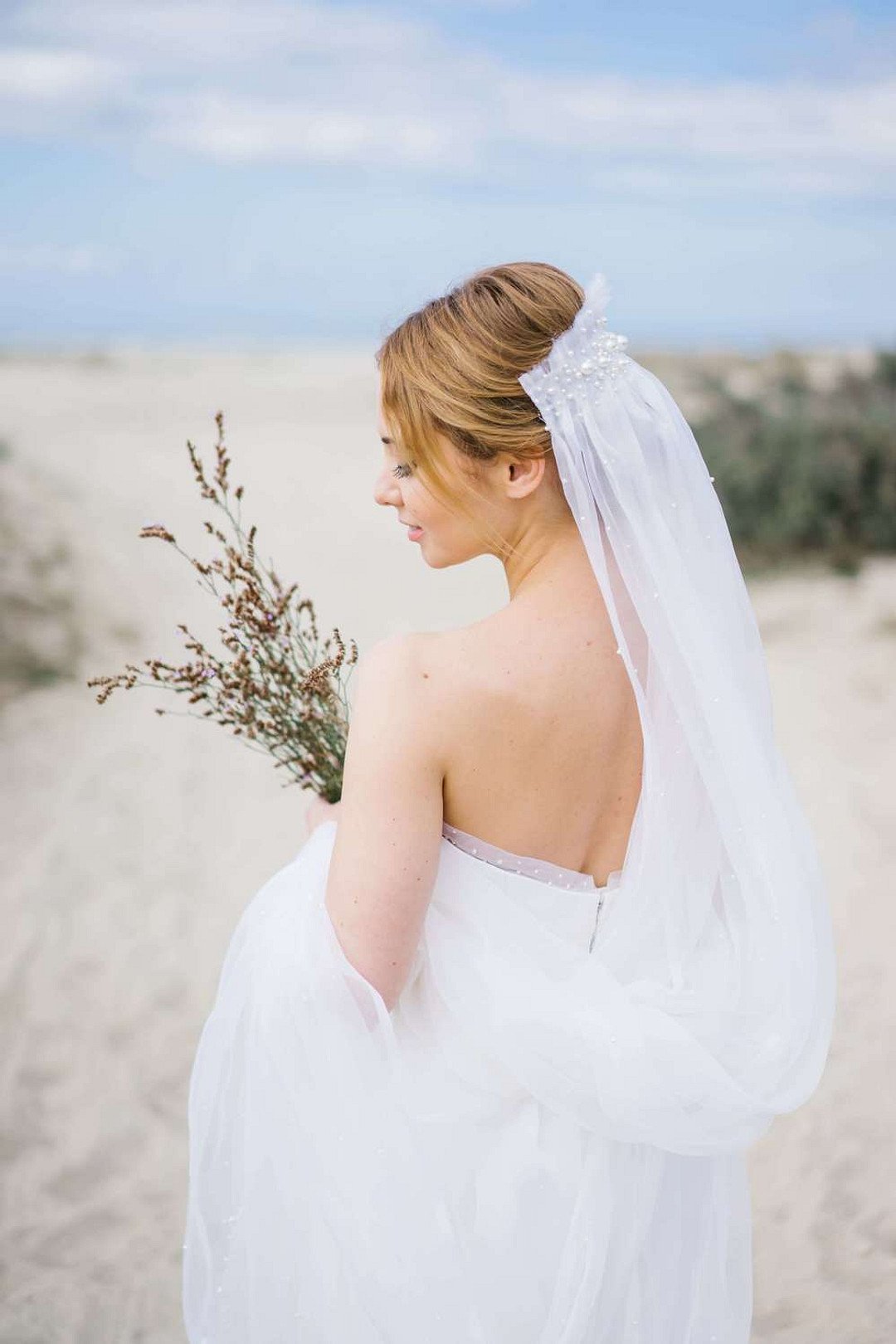 Bridal portrait on the beach in Greece with local dry flowers