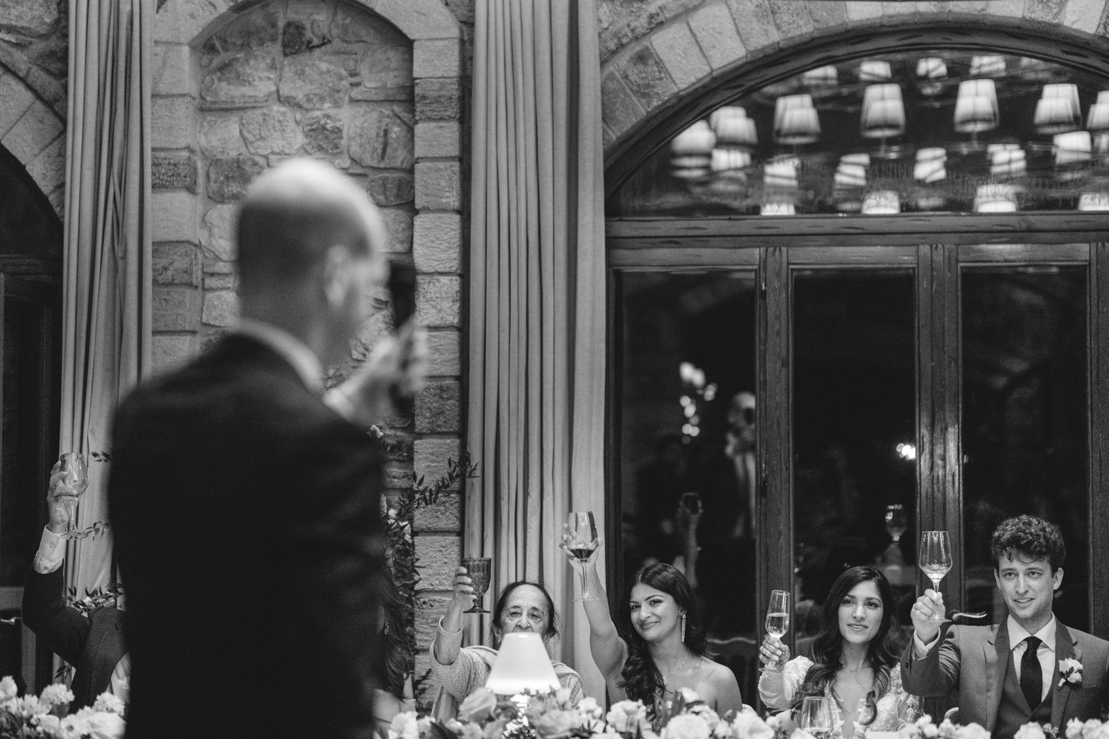 Guest giving a toast at the modern Christian wedding ceremony inside the Pyrgos Petreza venue in Greece