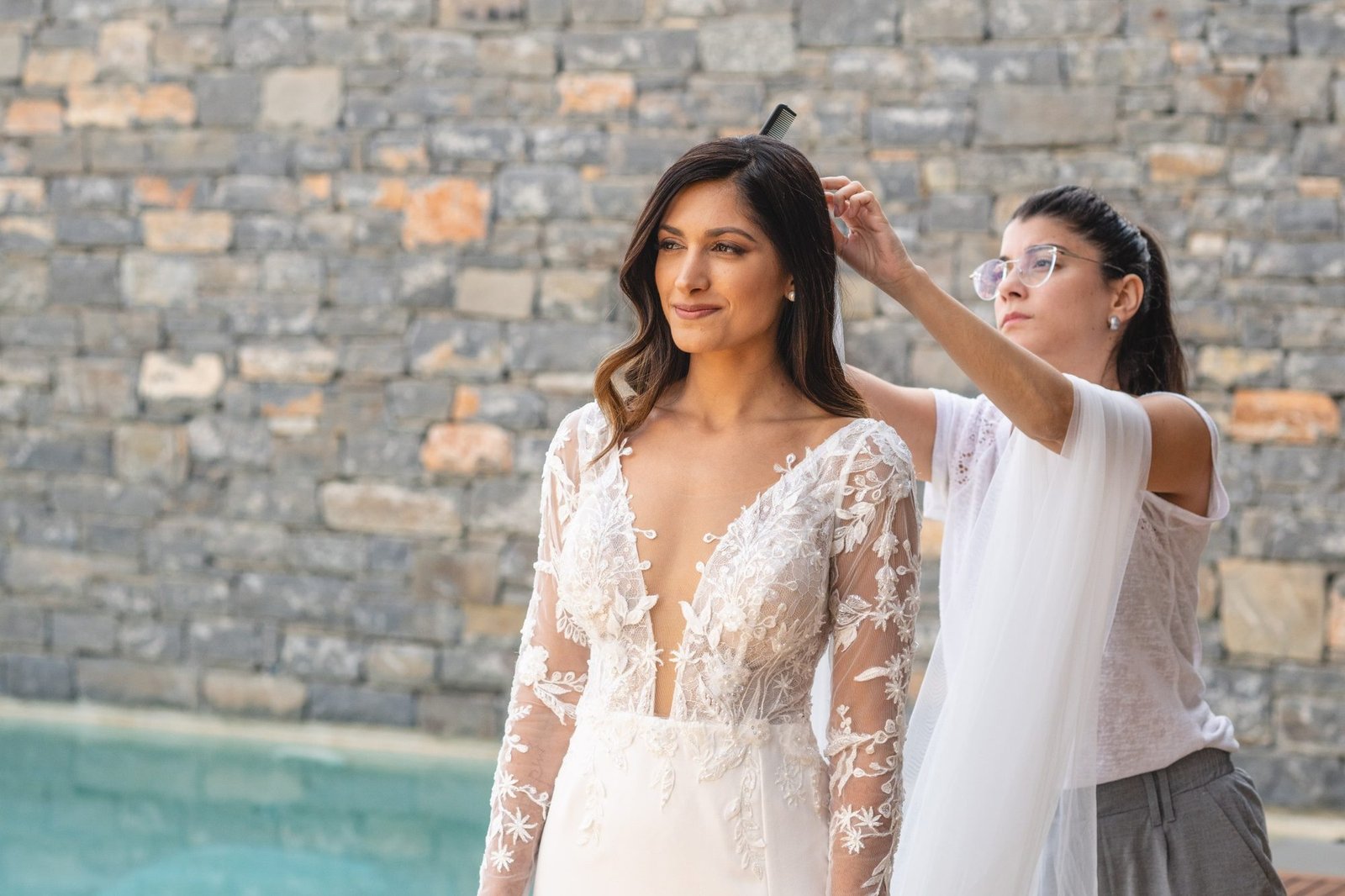 Bride in white lace dress getting ready