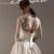 Back view of Nelly, dreamy wedding dress by Lihi Hod new collection featuring a dramatic silk Shantung ball gown, strapless sweetheart bodice topped with sheer delicate lace sleeves and a flattering dropped v-waist flowing into a voluminous skirt with rich architectural folds, a low back with satin-covered buttons down the back