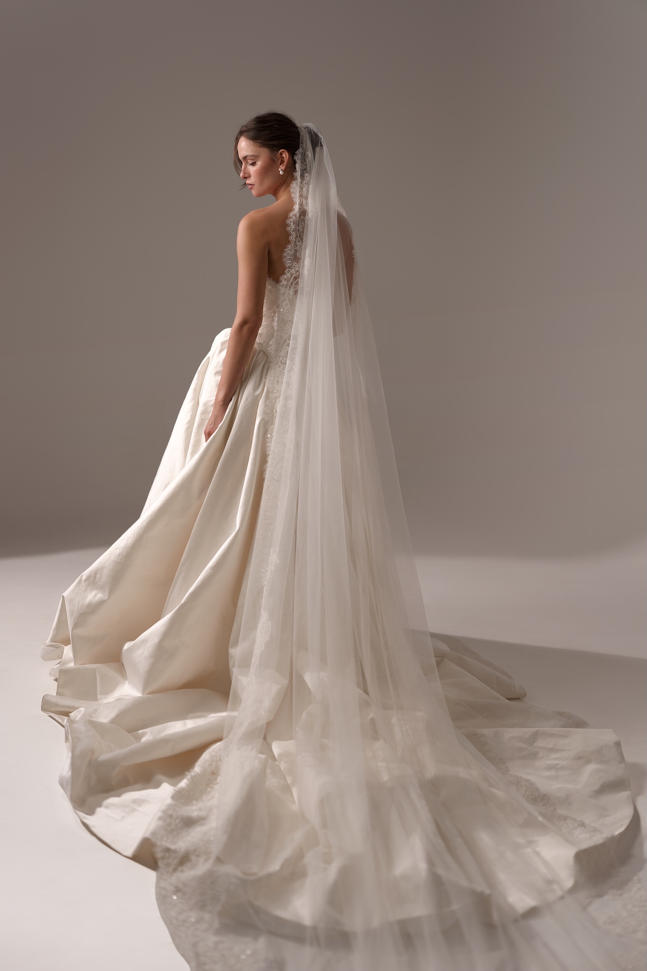 Back of the Odyssee by Lihi Hod dreamy wedding dress with silk duchess satin voluminous ballgown with a dramatic cathedral-length veil and train.