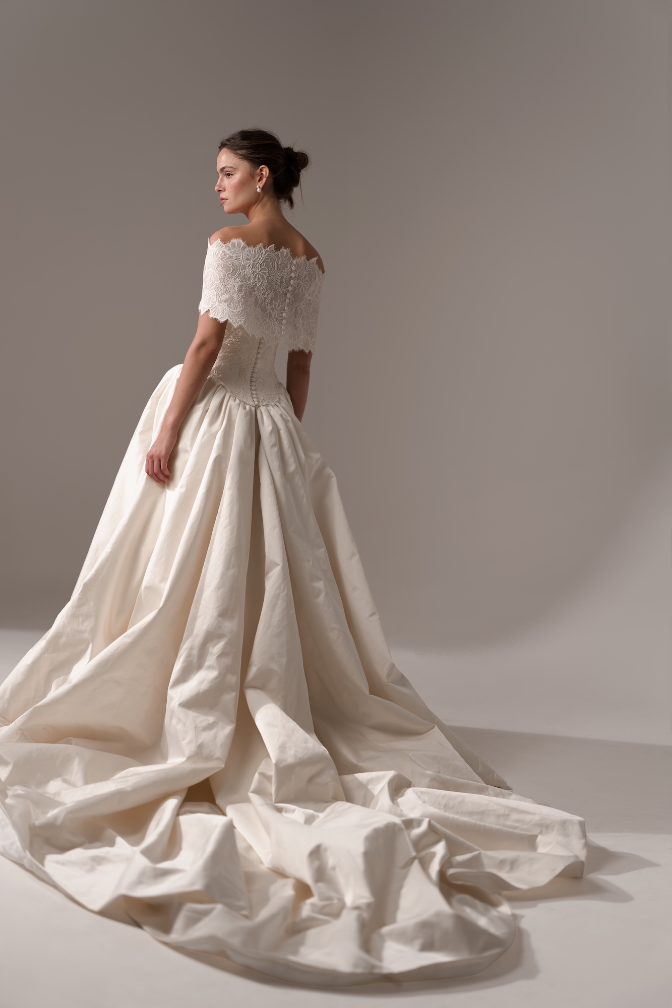 Back of the Odyssee by Lihi Hod, silk duchess satin ball gown with a corseted bodice, delicate lace topper with buttons down the waist and cathedral train.